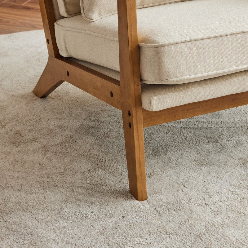 Poltrona d'accento rivestita in misto lino con gambe in legno e un cuscino, beige